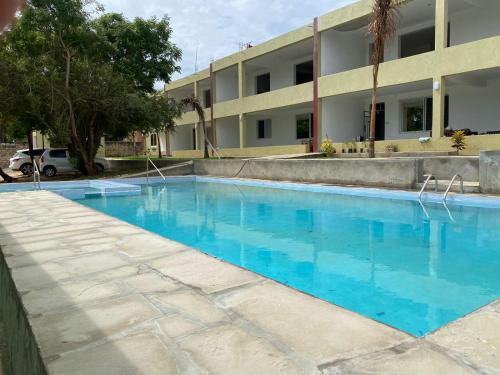 an empty swimming pool in front of a building at Jade luxury apartments Diani in Mombasa