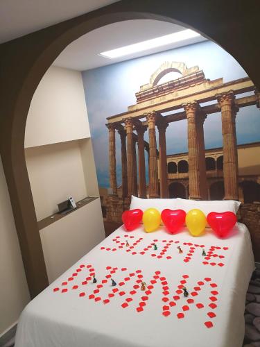 a bedroom with a bed with hearts on it at ERES EMÉRITA "Apartamentos & Suites" in Merida