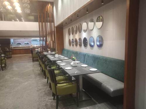 a dining room with long tables and chairs and mirrors at Hotel Svm Pride Banjara-Hot Live Counter-Road View Stay- Free Lavish Buffet Breakfast-18 Percent Off In Restaurant Food Order in Hyderabad