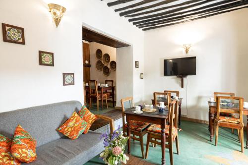 a living room with a couch and a table at Shaba Boutique Hotel in Zanzibar City