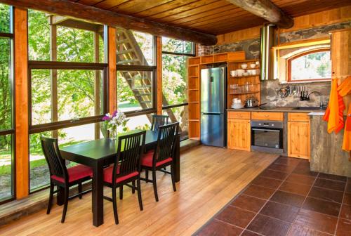 a kitchen with a table and chairs in a house at Truu Holiday Houses in Ivaste