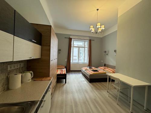 a kitchen and living room with a bed in a room at Boomerang Hostel in Budapest