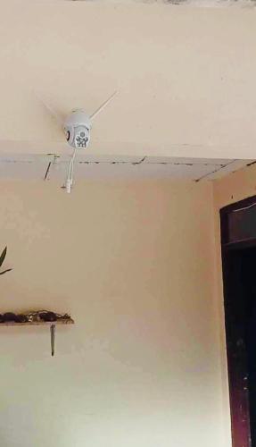 a ceiling fan in a room with a wall at ABIZA Homestay in Pañge