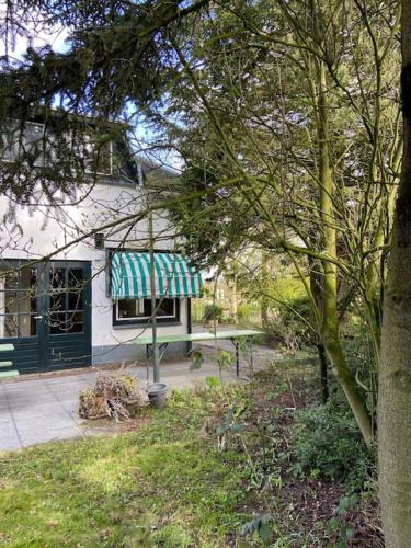 a house with a green and white awning on it at House on estate near Amsterdam and Keukenhof in Lisserbroek