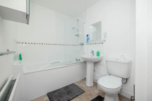 biała łazienka z toaletą i umywalką w obiekcie Dannyrex Apartments w mieście Northampton