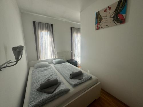 a bedroom with a bed with two pillows on it at K3 in Budapest