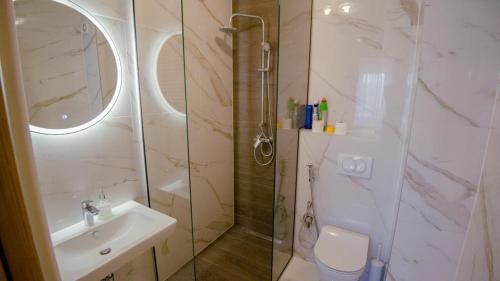 a bathroom with a shower and a sink and a toilet at Green Ilidza Apartment in Sarajevo