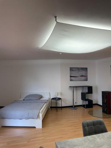 um quarto branco com uma cama e uma secretária em Apartment Weßling em Wessling