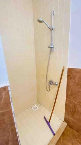 a shower in a bathroom with a tile floor at Lighthouse studio in Dahab