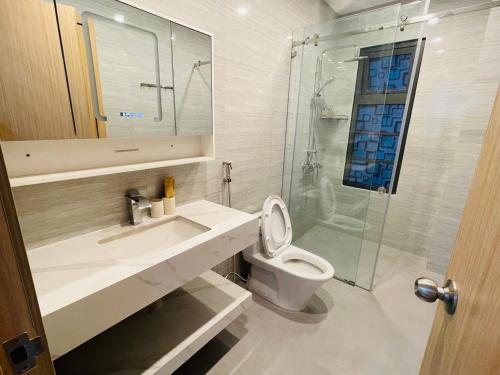 a bathroom with a sink and a toilet and a shower at Holiday Villa Novaworld Phan Thiet in Phan Thiet