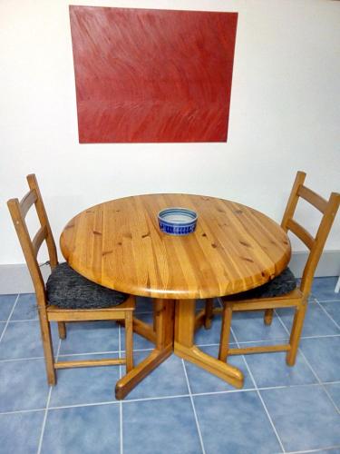 a wooden table with two chairs and a bowl on it at Brachelen in Hückelhoven