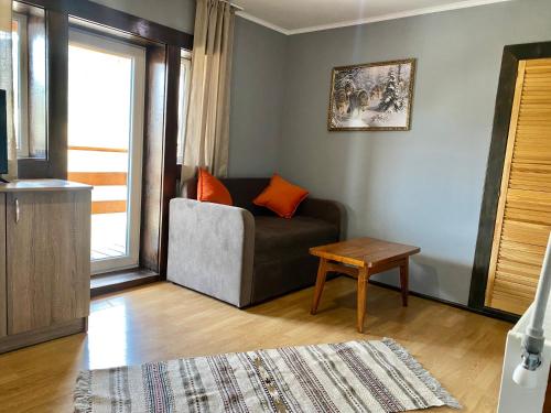 a living room with a couch and a table at Khatky Na Penkakh in Vorokhta