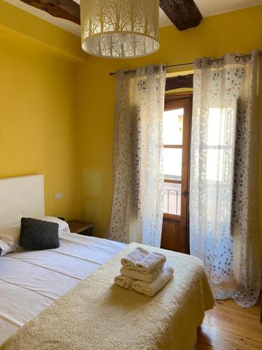 1 dormitorio con 1 cama con 2 toallas en Hotel Restaurante Agapio de TRESNIÑO en Quintanilla de Onésimo