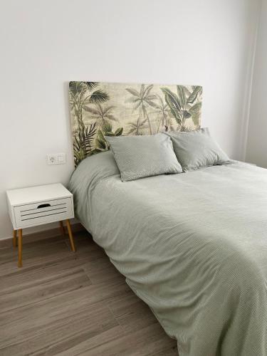 a bedroom with a bed and a nightstand next to it at Casa de Goya in Argés