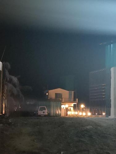 a car parked in front of a building at night at Jim's Inn in Rāmnagar