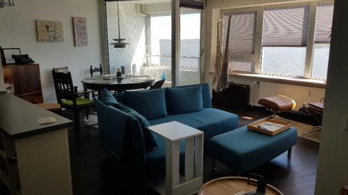 a living room with a blue couch and a table at Utspann in Schleswig