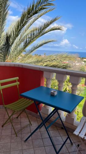 a blue table and a chair on a balcony at Borgo di Santa Barbara in Santa Domenica