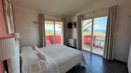 a bedroom with a bed and a view of the ocean at Borgo di Santa Barbara in Santa Domenica