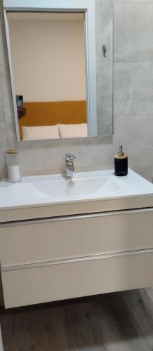 a bathroom with a white sink and a mirror at Louridoplaya in Poio