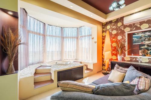 a living room with a couch and a desk at Paramithia Villa in Afantou