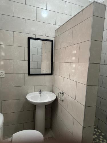 a bathroom with a sink and a mirror at the curve apartments unit 26 in Johannesburg