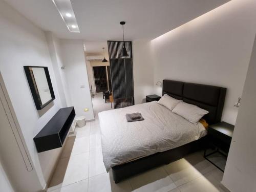 a bedroom with a bed and a mirror on the wall at No7 Boutique Apartments in Amman