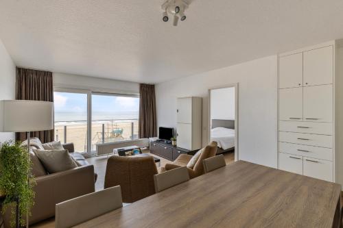 a living room with a couch and chairs and a bedroom at Atalanta 0303 b2 2ev in Wenduine