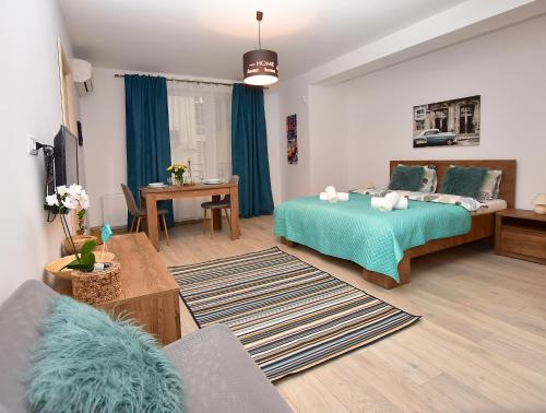 a bedroom with a bed and a living room at Near Cathedral Central Studio in Bucharest