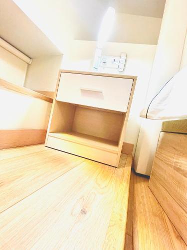 a small room with a bed and a wooden floor at MADRID CENTRO II in Madrid