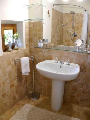 a bathroom with a sink and a shower and a mirror at Private Villa Dolce Vita in Lucignano