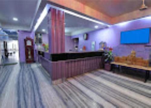 a bowling alley with lanes and a screen on the wall at Hotel Ellora Cooch Behar in Koch Bihār