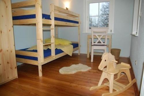 a bedroom with two bunk beds and a table at Komfortable Ferienwohnung in Brotterode mit Großem Balkon in Brotterode