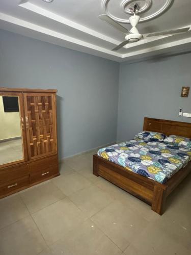 a bedroom with a bed and a ceiling fan at Prestige House in Ouagadougou