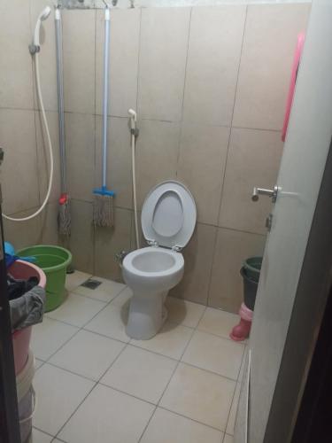 a small bathroom with a toilet and a shower at Kens home in Jakarta