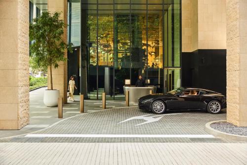 a black car parked in front of a building at COMO Metropolitan Singapore in Singapore