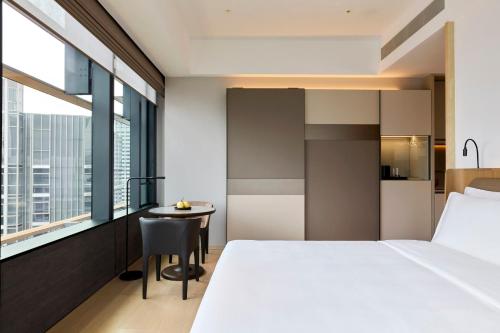 a hotel room with a bed and a table at COMO Metropolitan Singapore in Singapore