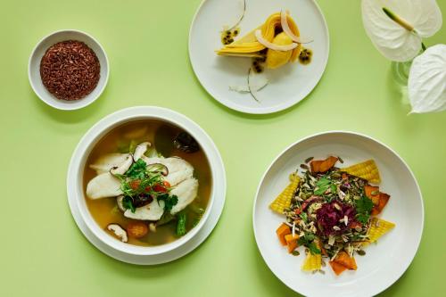 a table with bowls of soup and plates of food at COMO Metropolitan Singapore in Singapore