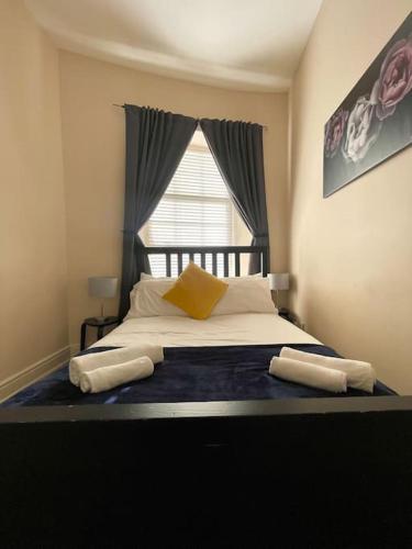 a bedroom with a large bed with a window at City Gem - Central & Stylish 1 Bed Apartment in Dublin