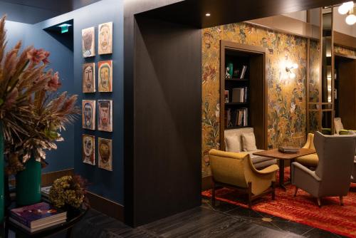 a room with a table and chairs and a book shelf at Umiltà 36 in Rome