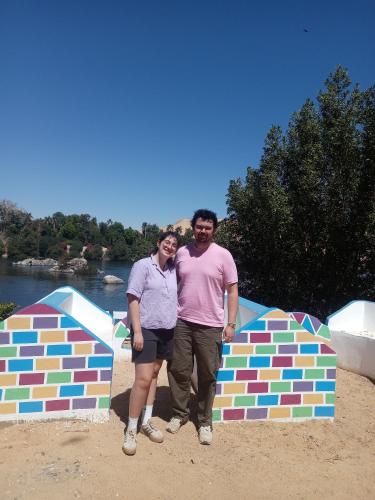 a man and woman standing in front of a colorful structure at Baba Dool in Aswan