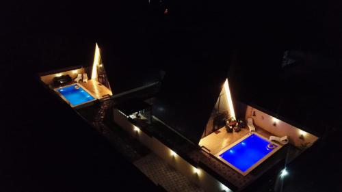 an aerial view of two swimming pools at night at Gabala Twin A Frame Villas in Gabala