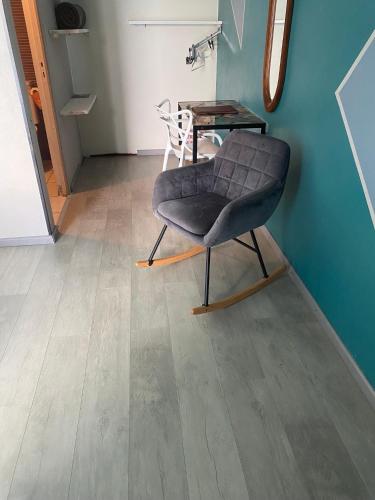 a chair sitting in a room with a table at Hôtel Le Soleil Couchant in Saint-Pierre
