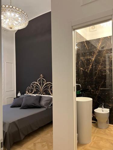 a bedroom with a bed and a sink and a mirror at Fiorentine Relais in Naples