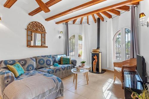 a living room with a couch and a tv at Villa Domingo - PlusHolidays in Benissa