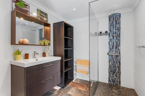 a bathroom with a sink and a glass shower at Villa Domingo - PlusHolidays in Benissa