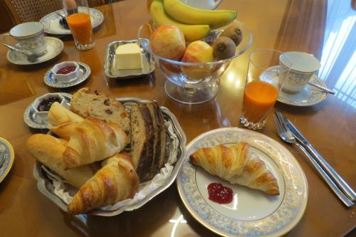 a table topped with plates of pastries and fruit at Molibeau in Beauvais