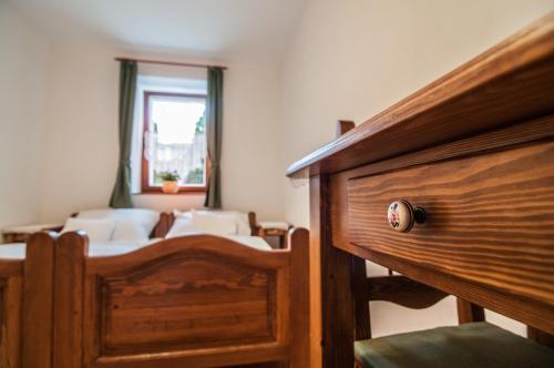 a room with a bedroom with a bed and a window at Zsirai Guest House in Mád