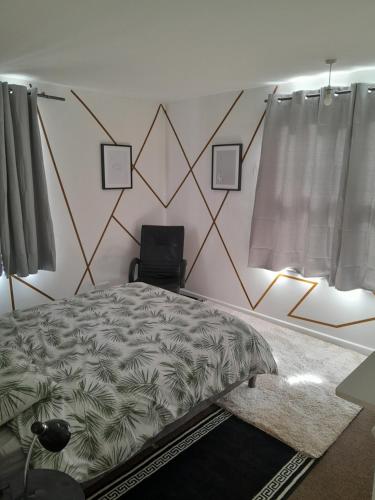 a bedroom with a bed and a wall with geometric patterns at Bobi in Sheffield