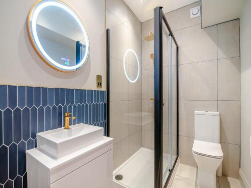 a bathroom with a sink toilet and a mirror at Bettys Townhouse-uk45308 in Harrogate