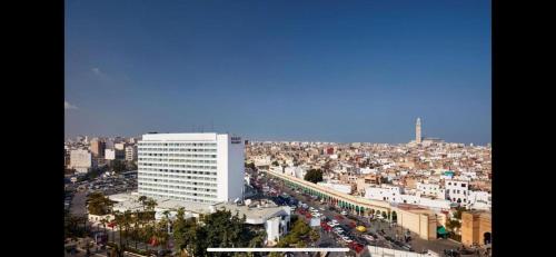 a view of a city with a large white building at اقامة الهام in Casablanca